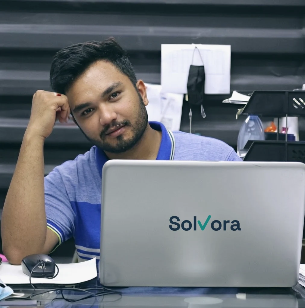 Osama Jahangir, founder of Solvora, at his laptop